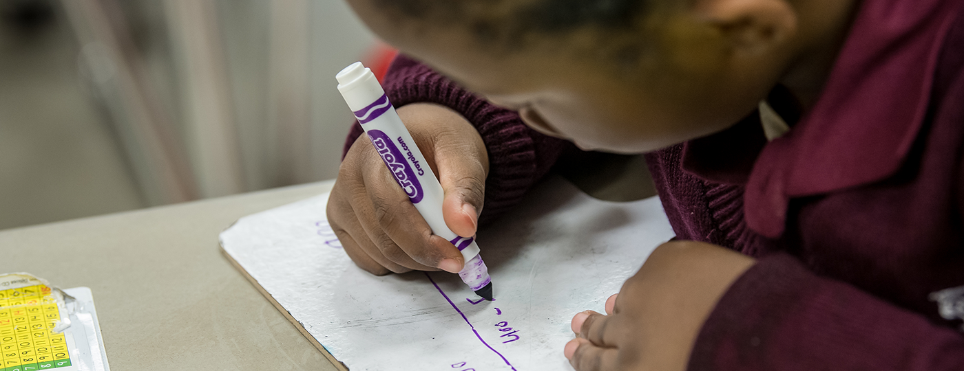 student writing on a paper