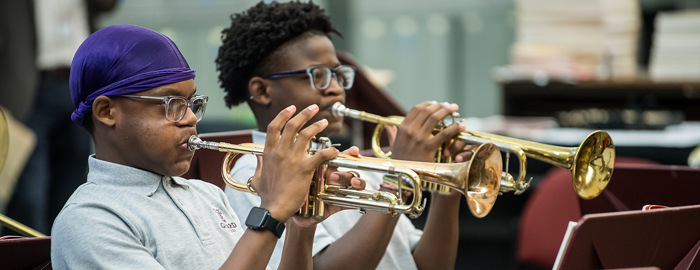 students playing trumpets in a music class