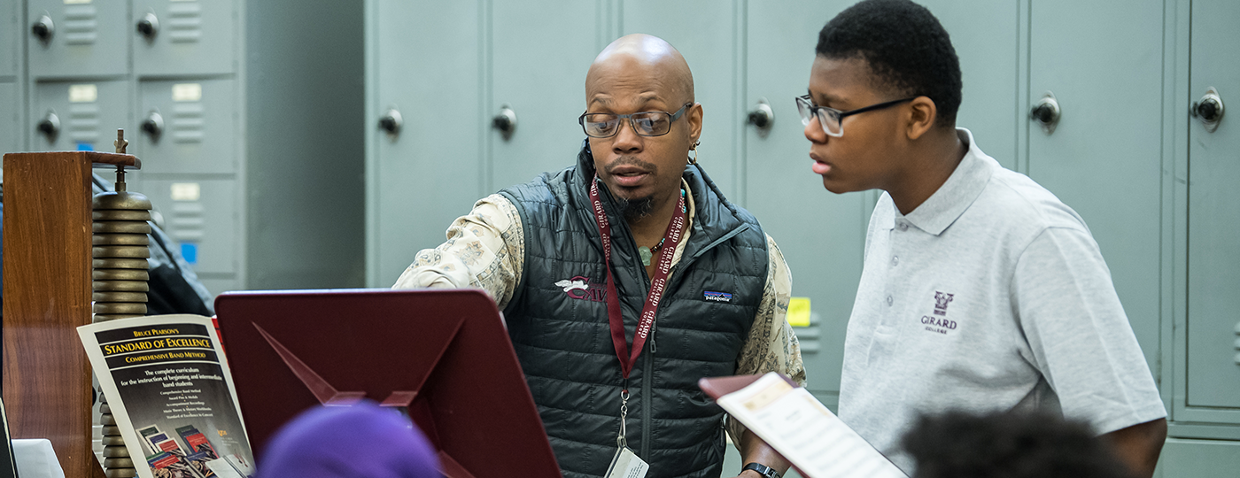 student and a teacher in a classroom