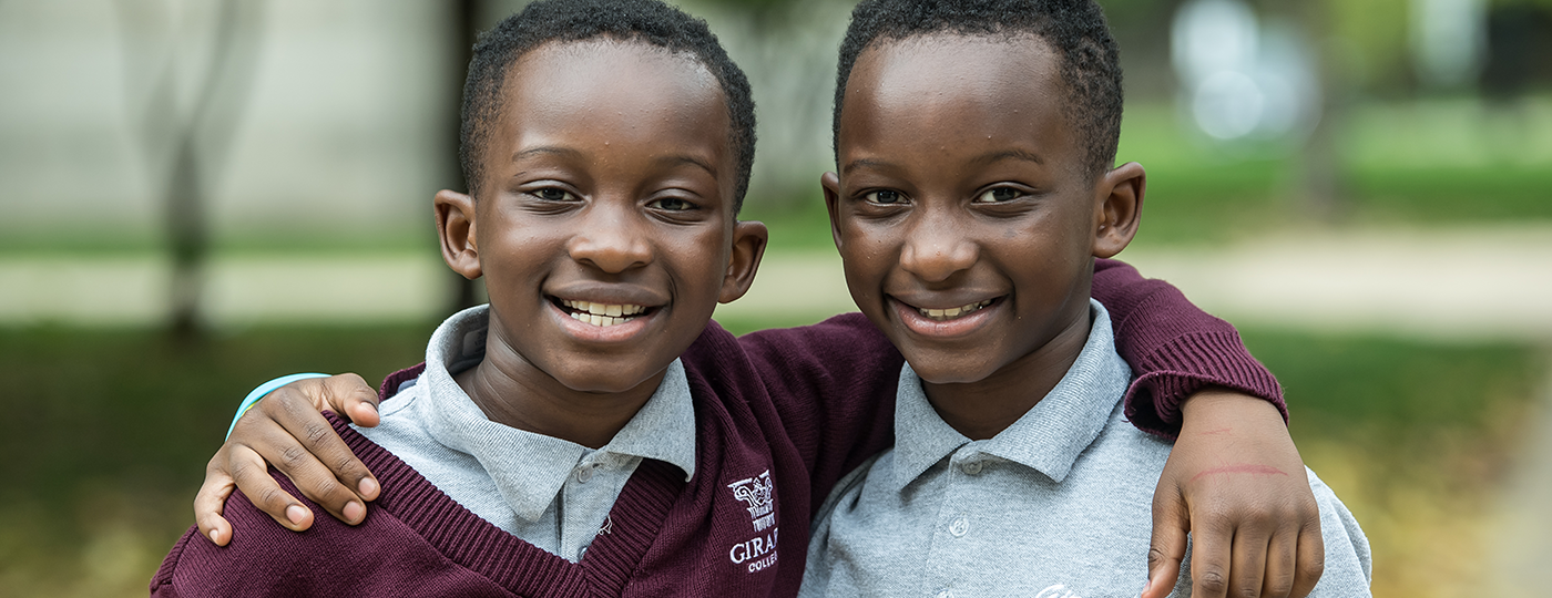 two young students smiling at the camera