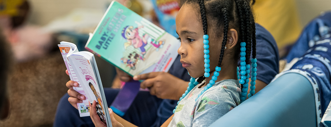 young student reading a book