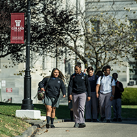 students walking outside on campus