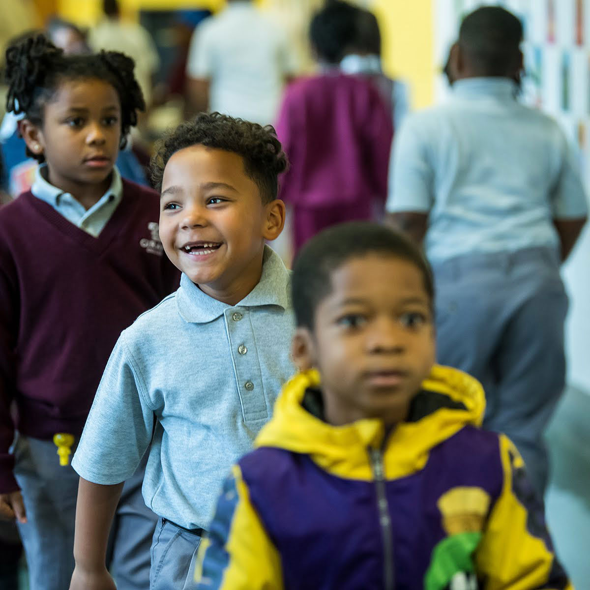 young students walking in a school hallway
